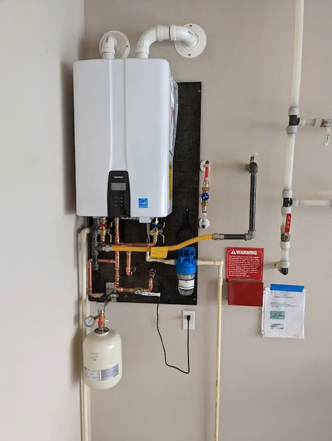 Professional plumber installing copper piping in a Bellwood home